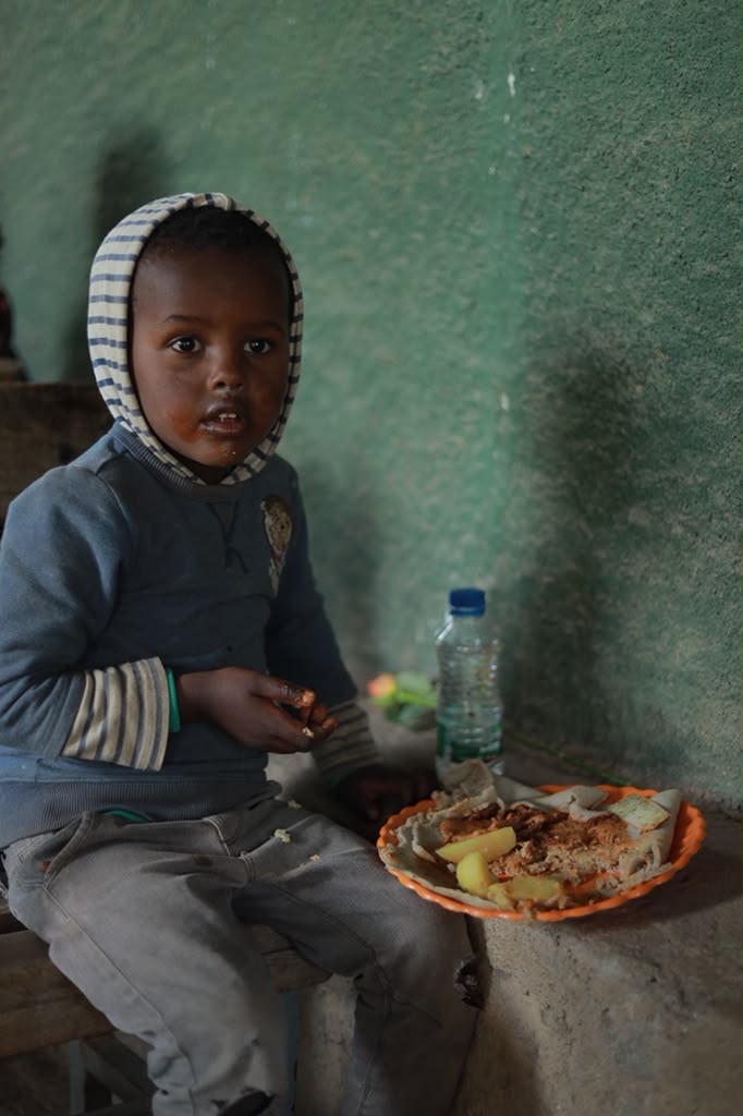 Young boy eating a meal indoors