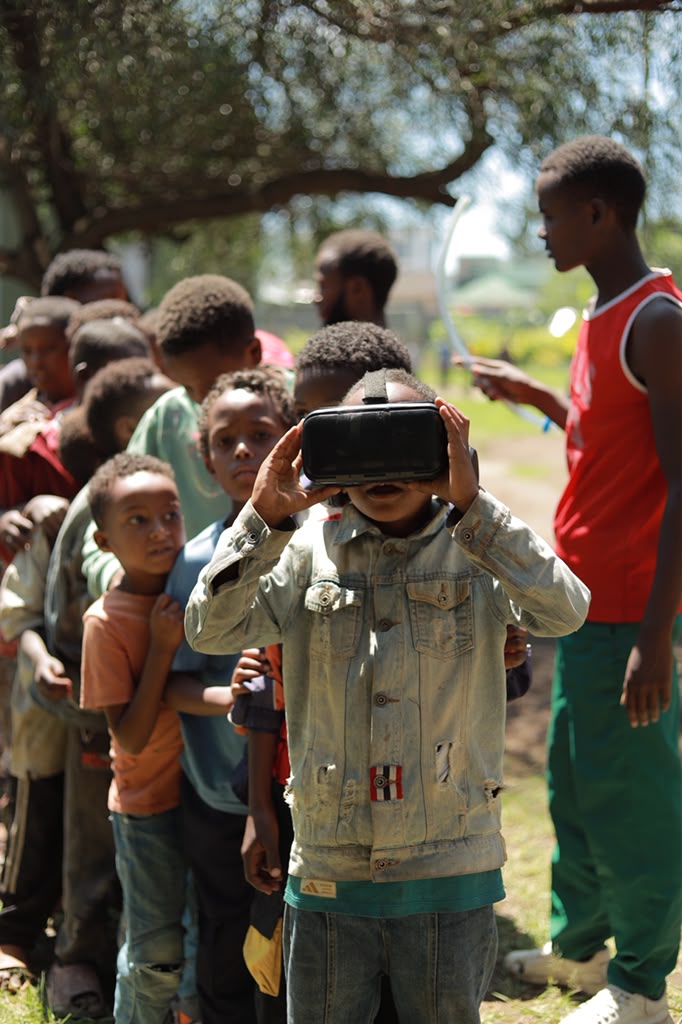 Line of children waiting to try a VR headset