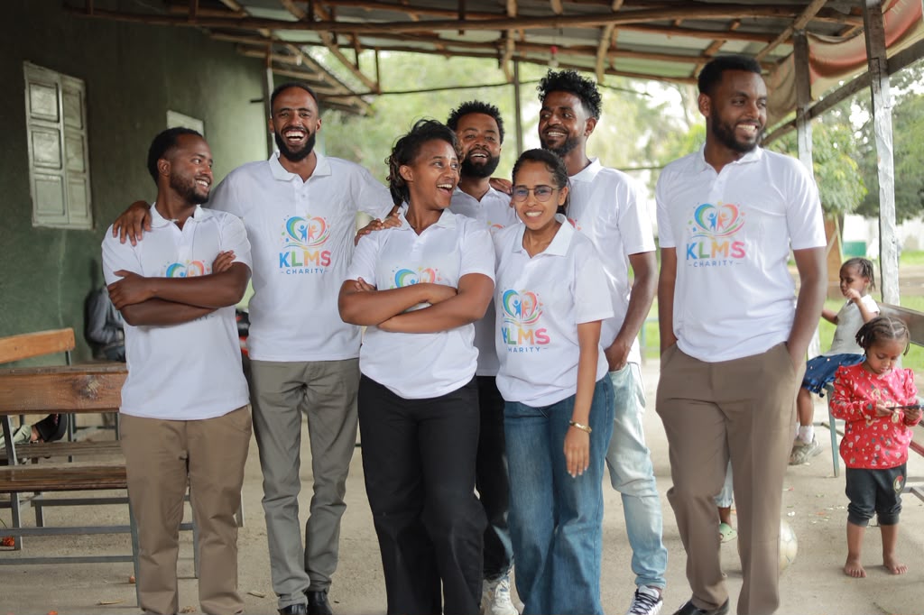 Group of KLMS team members in matching charity polo shirts